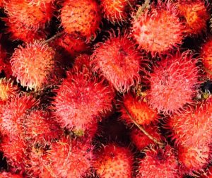 Bunch of red rambutans at a market in Cambodia