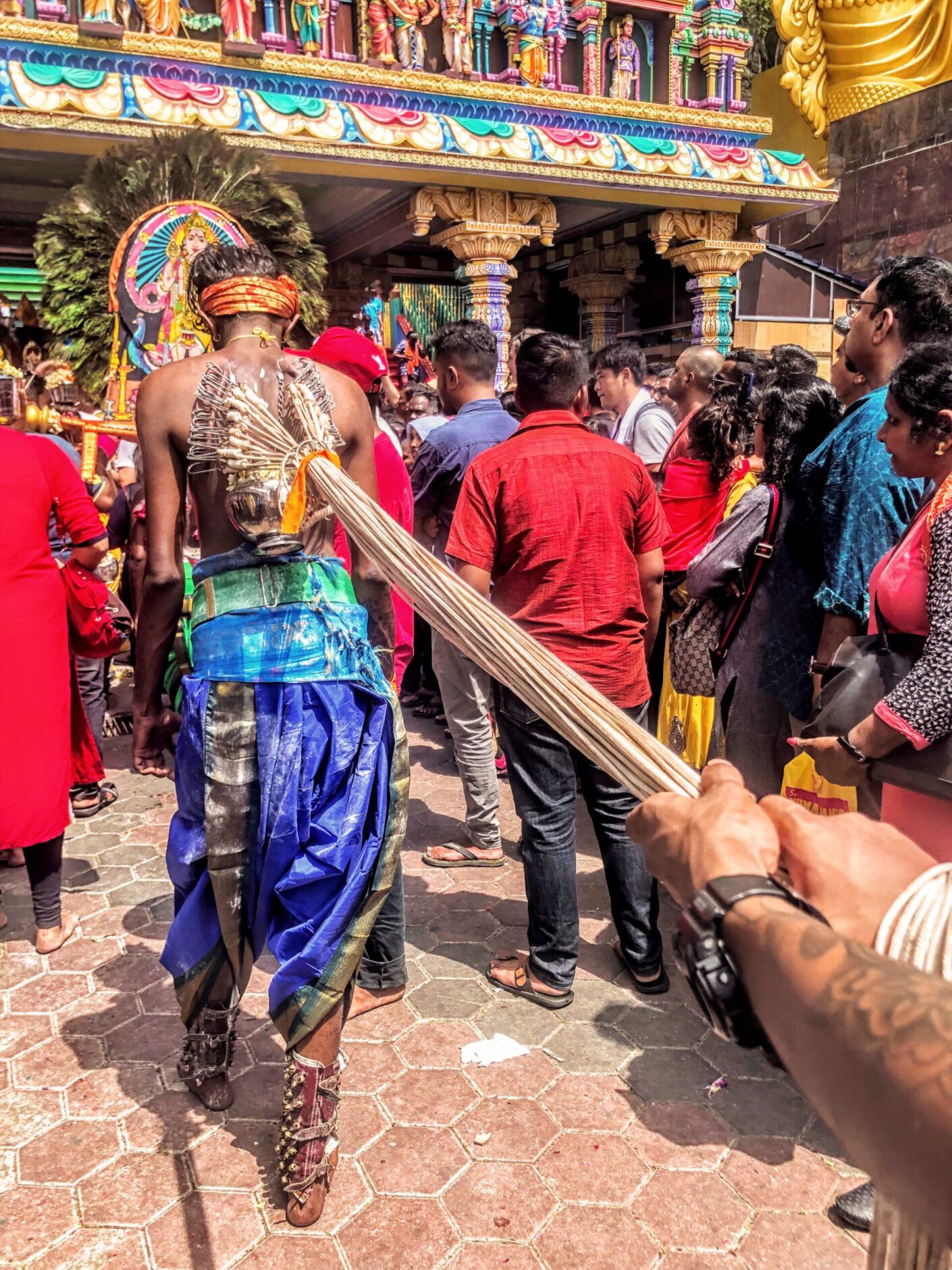 A man wearing blue pants with hooks in his back