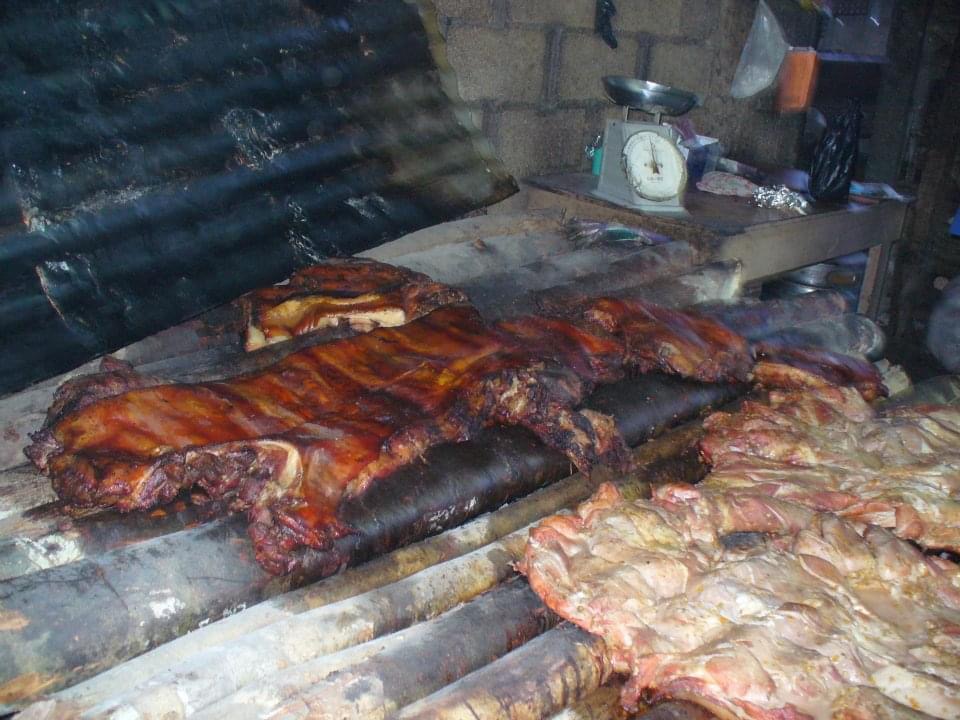 Jerk chicken being cooked on a grill at Scotchies in Montego Bay in Jamaica