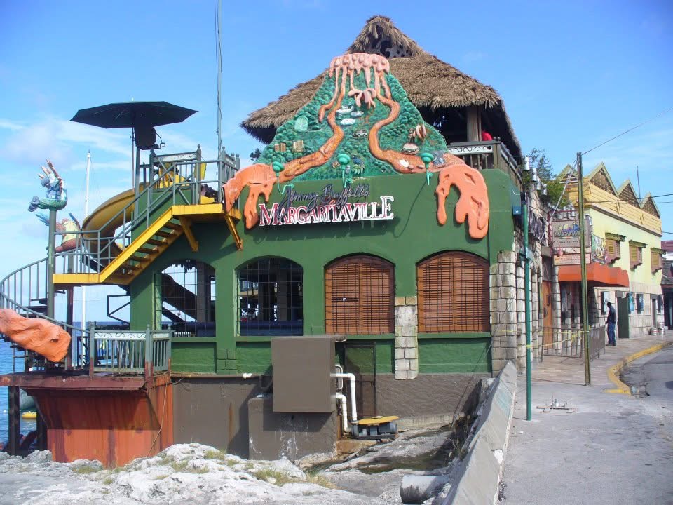 Green volcano with orange lava sculpture on the green building of MargaritaVille in Montego Bay in Jamaica