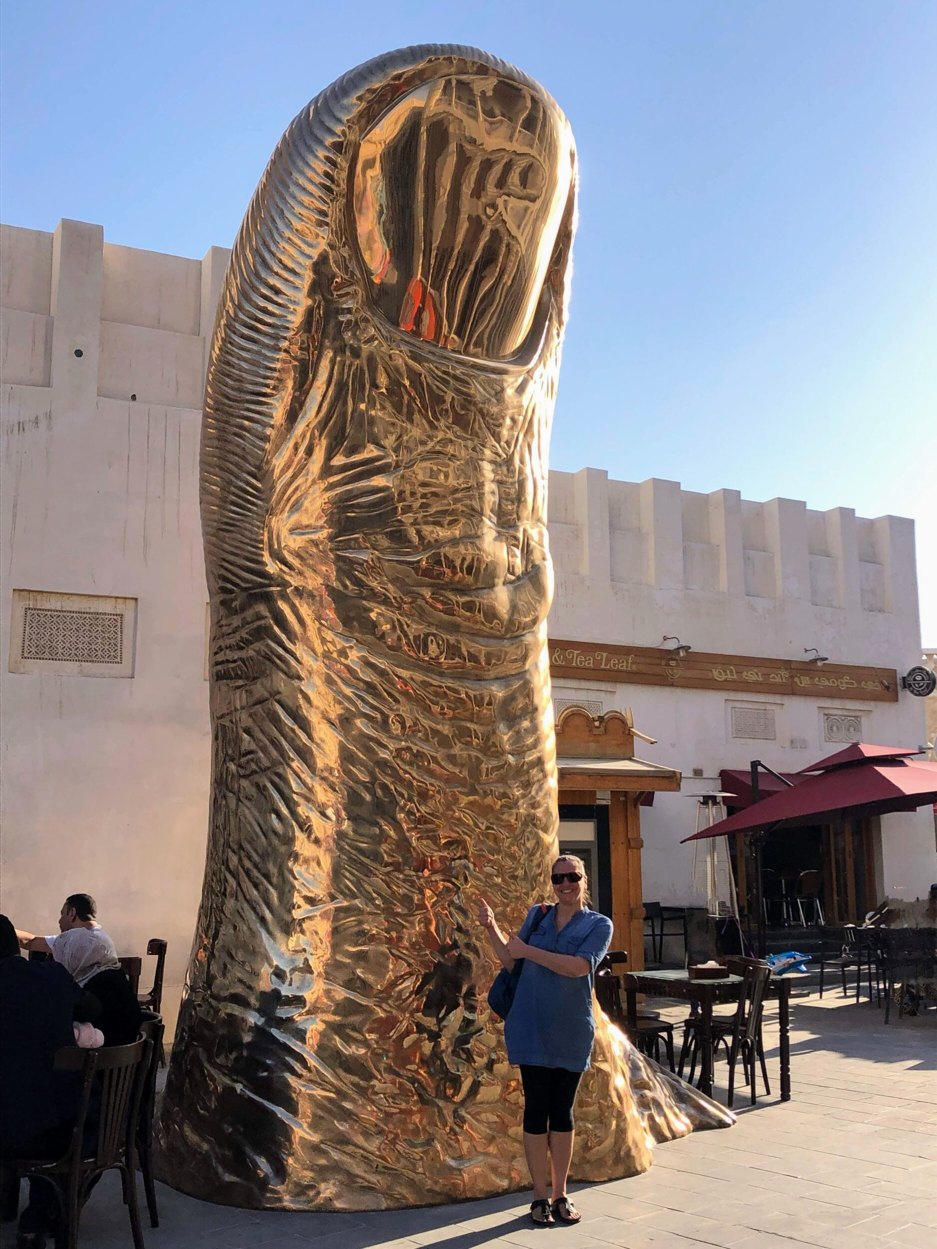 Giant golden bronze thumb Le Pouce in Souq Waqif in Doha, Qatar